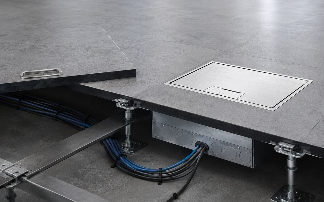 Recessed floor box and cable connections installed beneath a raised access floor panel